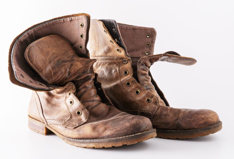 Old shoes on a white background. Leather brown shoe. Worn shoes.